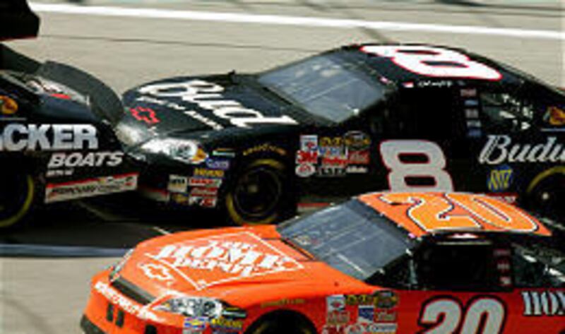 Dale Earnhardt Jr. (8) bump-drafts behind Martin Truex Jr. during a practice session Friday at the tri-oval Talladega Superspeeday.