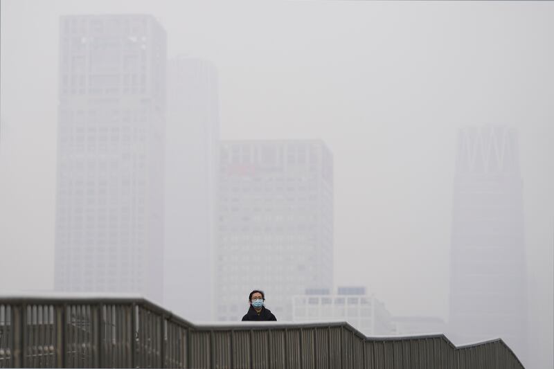 Pollution shrouds high-rise buildings in Beijing, China, on Nov. 18, 2021,
