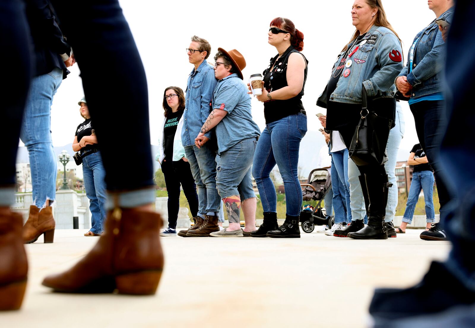 People listen to speakers during Denim Day at the Capitol in Salt Lake City on Wednesday, April 27, 2022.