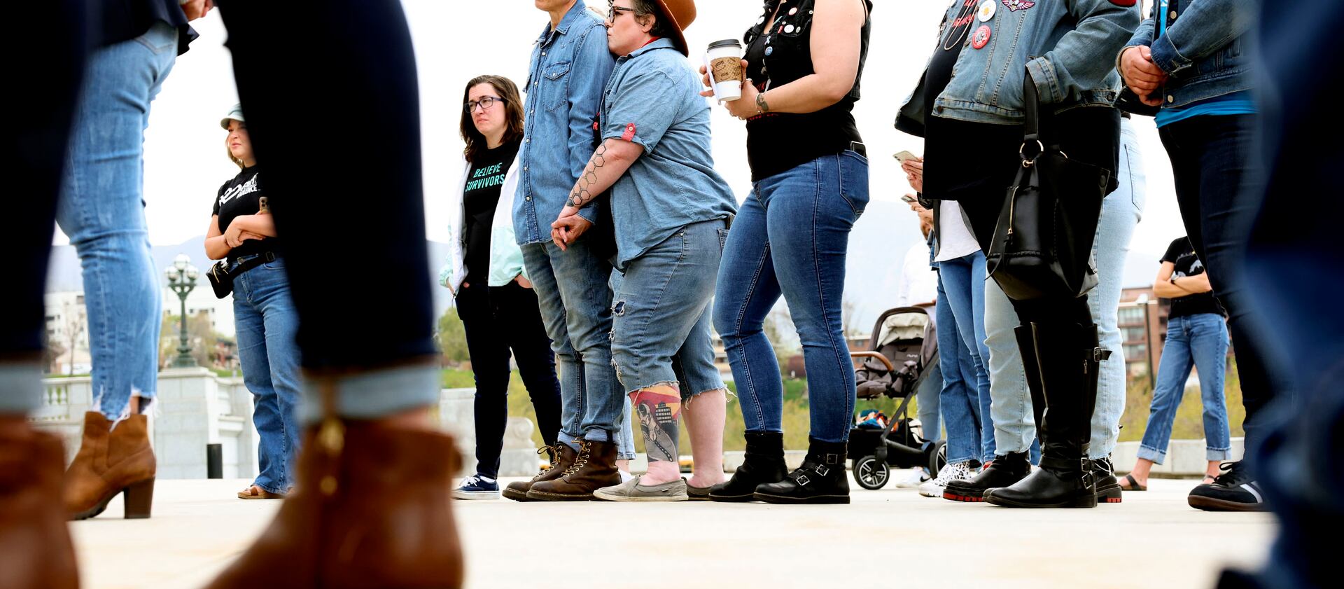 People listen to speakers during Denim Day at the Capitol in Salt Lake City on Wednesday, April 27, 2022.