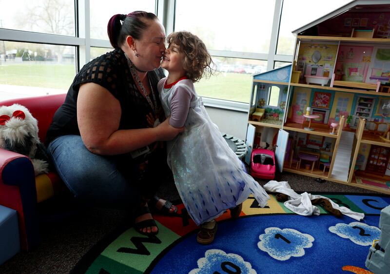 Preschool teacher Kristen Stevenson laughs with Jonah Gonzales, 4, who chose to wear an Elsa dress during playtime.