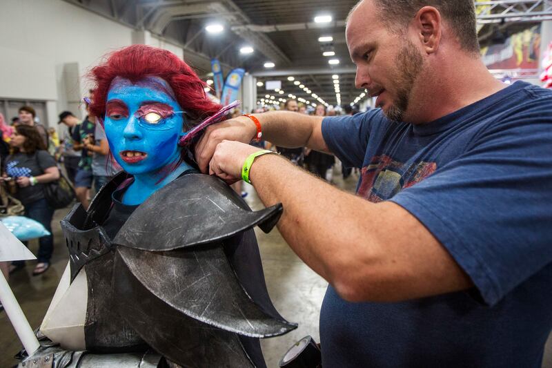 James Douglass, right, helps Calandra Crowley fix her outfit during the FanX Salt Lake Comic Convention at the Salt Palace Convention Center in Salt Lake City on Saturday, Sept. 8, 2018.