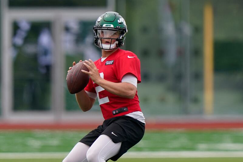 New York Jets quarterback Zach Wilson drops back for a pass during an NFL practice.
