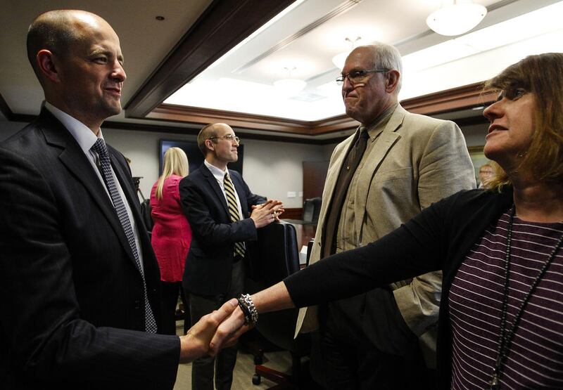 FILE — Evan McMullin, left, who's running for the Independent Presidential Bid, shakes hands with reporter, Lisa Roche during a meeting with the Deseret News and KSL editorial board in Salt Lake City on Wednesday, Aug. 10, 2016.