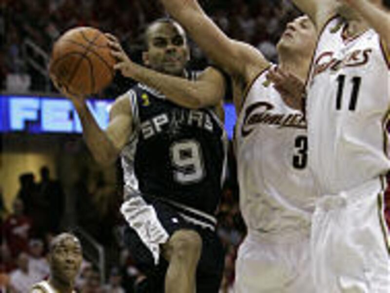 San Antonio's Tony Parker, left, passes around Cleveland's Sasha Pavlovic, center, and Zydrunas Ilgauskas.