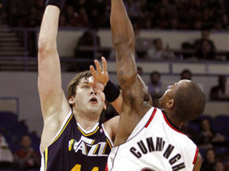 Jazz center Kyrylo Fesenko, who had 18 points, shoots over Blazers forward Dante Cunningham.