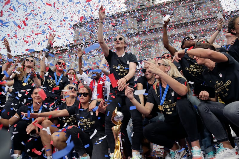 The U.S. women's soccer team, Megan Rapinoe center, celebrates at City Hall after a ticker tape parade, Wednesday, July 10, 2019, in New York. The U.S. national team beat the Netherlands 2-0 to capture a record fourth Women's World Cup title. (AP Photo/Se