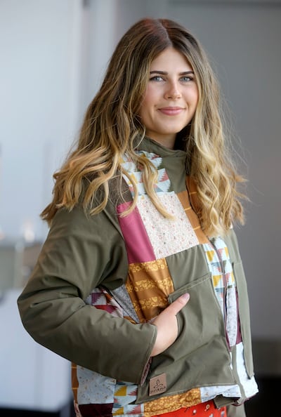 Morgan Erickson, a graduate from Utah State University's new outdoor product design and development program, poses for a photo in a coat she designed from upcycled materials, after graduation at the Dee Glen Smith Spectrum in Logan on Thursday, May 2, 201