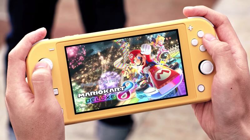 Mario Kart 8 Deluxe is shown running on a yellow handheld-only Nintendo Switch Lite.