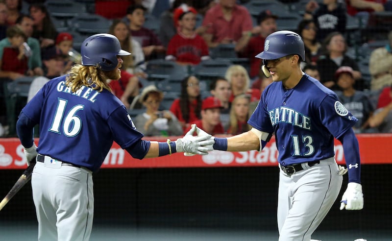 Seattle Mariners' Jacob Hannemann (13) is congratulated by Ben Gamel on his home run against the Los Angeles Angels in Anaheim, Calif., Saturday, Sept. 30, 2017.