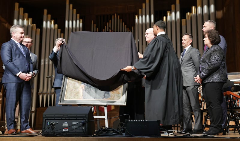 A group of eight people lift the drapes off of a portrait of Joseph Smith at the Morehouse College Martin Luther King Jr. International Chapel in Atlanta, Georgia, on Sunday, Feb. 1, 2026.