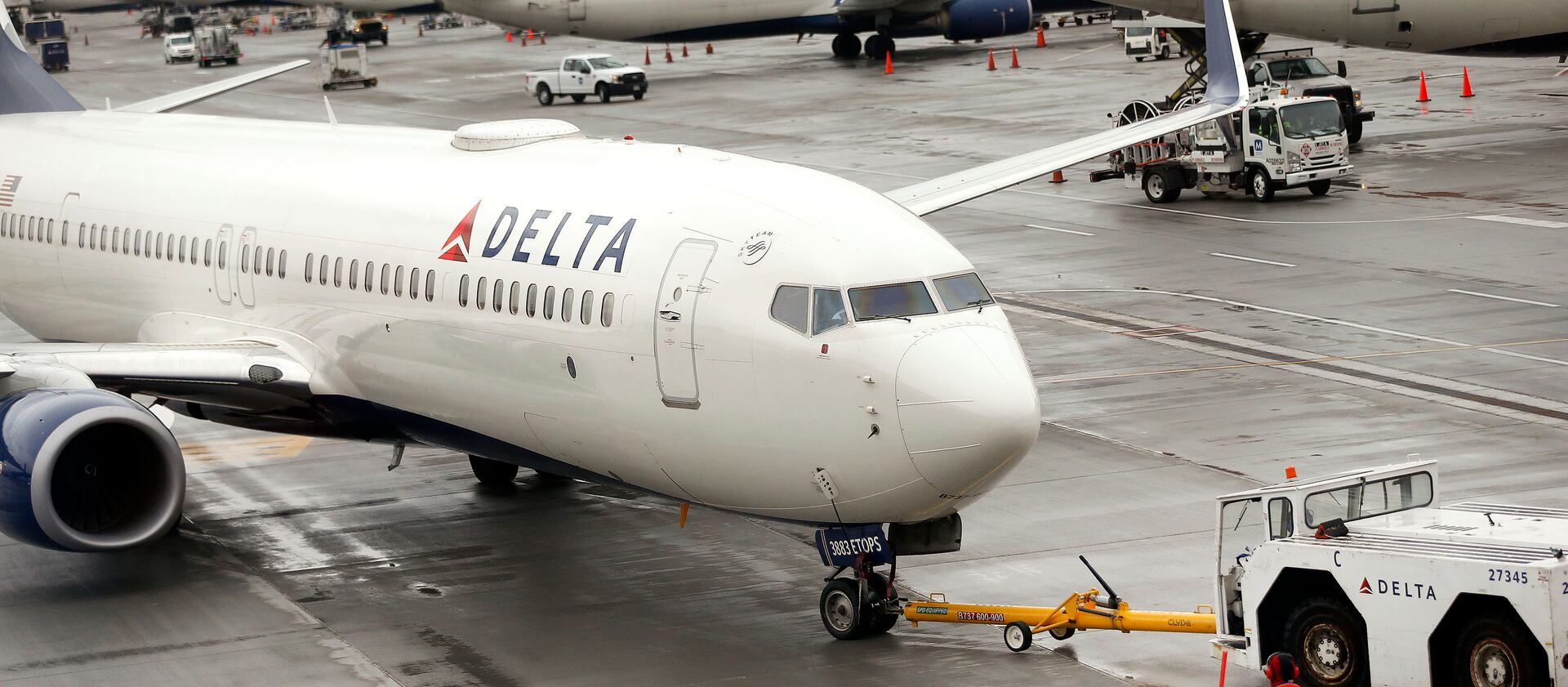 A Delta plane departs from a hangar at the Salt Lake City International Airport.