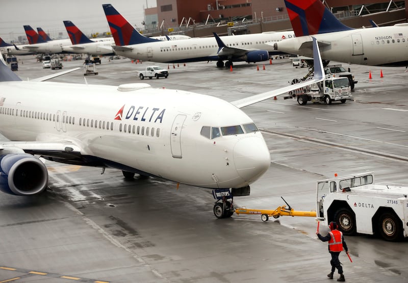 A Delta plane departs from a hangar at the Salt Lake City International Airport.