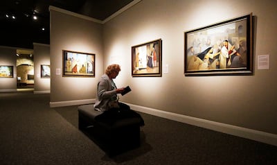 Myriam Verbauwen, wife of Argentine artist Jorge Cocco Santángelo, enjoys a display of her husband's artwork at the Church History Museum in Salt Lake City on Thursday, May 17, 2018.