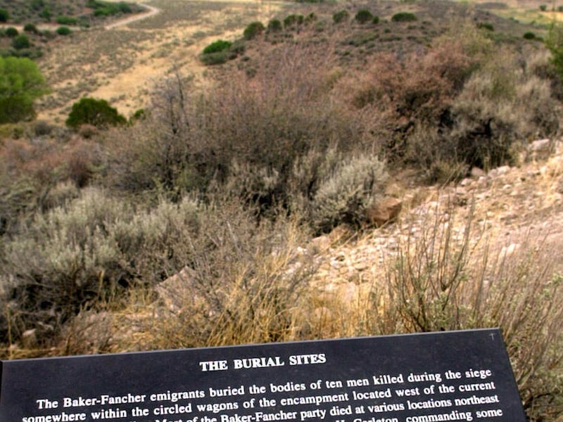 FILE - In this July 17, 2002 file photo, a marker describes the Mountain Meadows burial site which is in the valley, at rear, in Mountain Meadows, Utah. This southern Utah site where Mormons massacred members of a 19th Century Arkansas wagon train has be