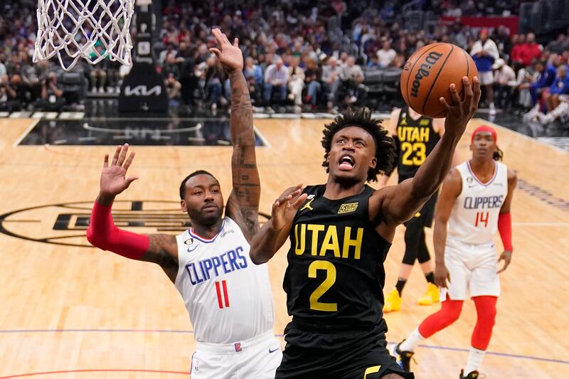 Utah Jazz guard Collin Sexton, right, shoots as Los Angeles Clippers guard John Wall defends during the second half of an NBA basketball game Sunday, Nov. 6, 2022, in Los Angeles.