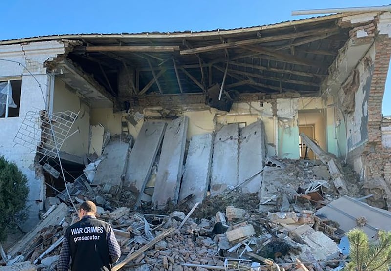 A war crimes prosecutor inspects the site of a night Russian drone attack in Izmail, Ukraine, on Sept. 7, 2023.