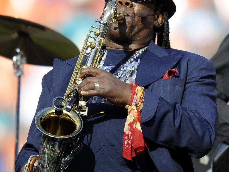 FILE - Saxophonist Clarence Clemons performs during halftime of the Tennessee Titans against the Miami Dolphins NFL football game, in this Nov. 14, 2010 file photo taken in Miami. Clemons is playing the national anthem on Sunday Dec. 12, 2010 at the Jets-