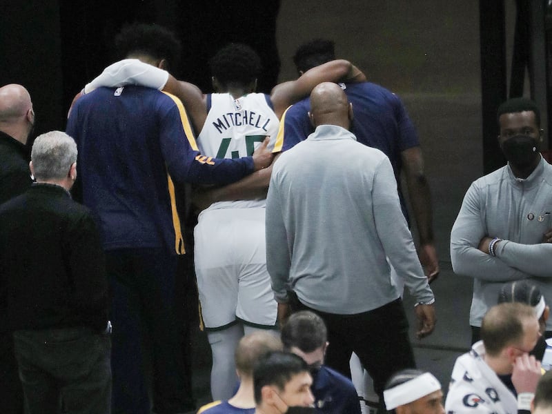 Utah Jazz guard Donovan Mitchell (45) is helped off the court and to the locker room after being injured against the Indiana Pacers in Salt Lake City on Friday, April 16, 2021.