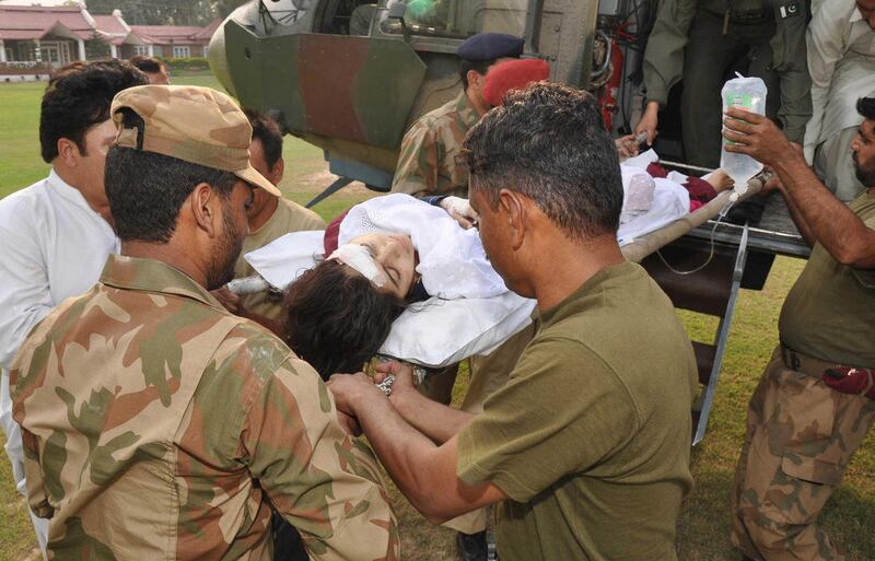 In this photo released by Inter Services Public Relations department, Pakistani soldiers carry wounded Pakistani girl, Malala Yousufzai, from a military helicopter to a military hospital in Peshawar, Pakistan. A Taliban gunman walked up to a bus taking ch