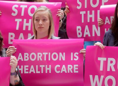Ocean Candler and others hold signs during a press conference at the Capitol in Salt Lake City on Wednesday, April 10, 2019, where the Planned Parenthood Association of Utah announced a lawsuit filed by the ACLU of Utah over a newly passed law that bans a