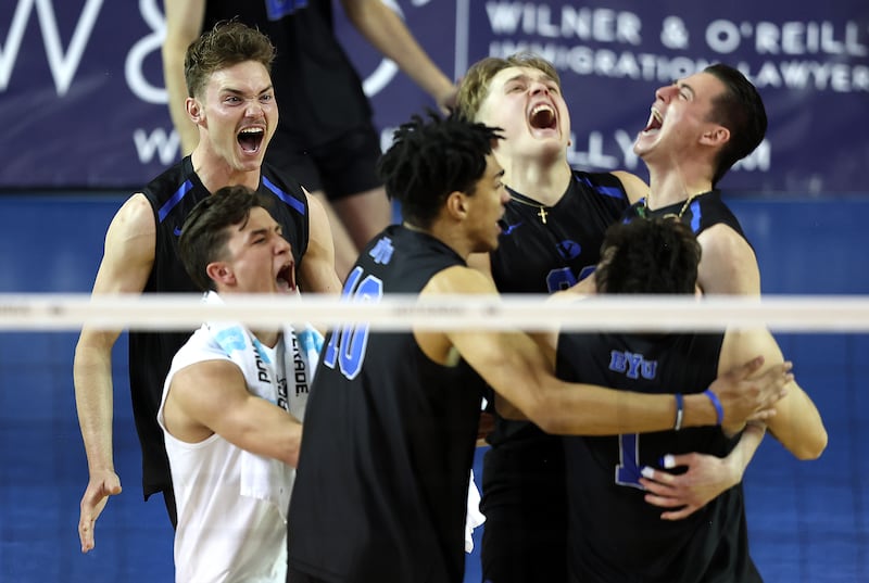 BYU players swarm Jon Stanley after scoring the match winning point as the Cougars defeat Pepperdine.