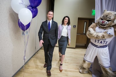 Brad L. Mortensen, vice president of university advancement at Weber State University, and his wife Camille Mortensen walk out from behind a curtain after Mortensen is named the university’s 13th president at the school's Shepherd Union building in Ogden
