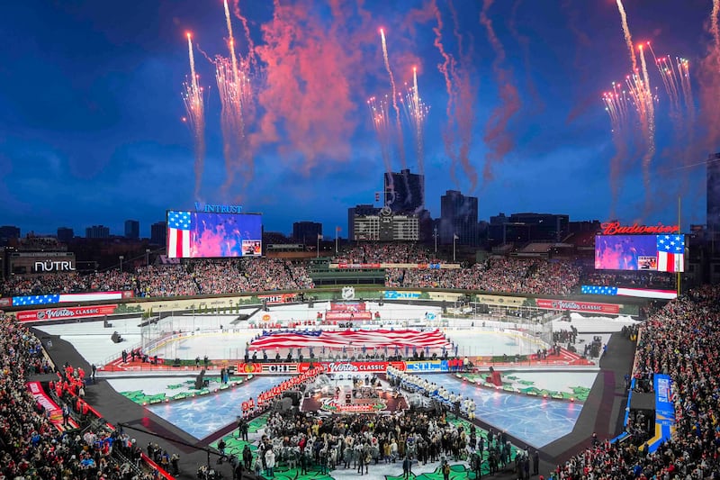 Fireworks explode during the Star-Spangled Banner before the NHL Winter Classic outdoor game featuring the Chicago Blackhawks and St. Louis Blues at Wrigley Field, Tuesday, Dec. 31, 2024, in Chicago.
