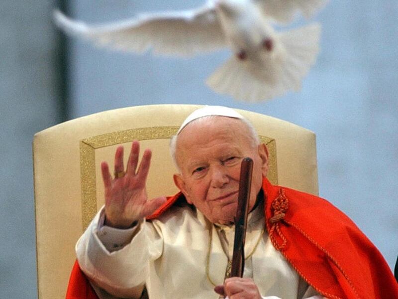 FILE - This April 10, 2003 file photo shows Pope John Paul II as a white dove is released in honor of his repeated calls for peace by Roman youths, in St. Peter's Square at the Vatican. The pope has approved a miracle attributed to Pope John Paul II's int