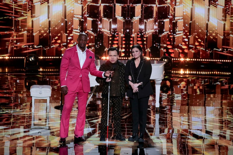 “AGT: Fantasy League” host Terry Crews stands with Kodi Lee and his mom, Tina Lee.