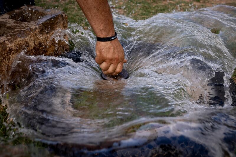 Kelby Iverson opens an irrigation valve to flood an orchard on his property in Hurricane on Sept. 8, 2022.