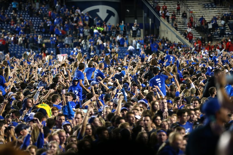 Fans swarm the field after BYU beat Utah in at LaVell Edwards Stadium in Provo on Saturday, Sept. 11, 2021. BYU won 26-17.