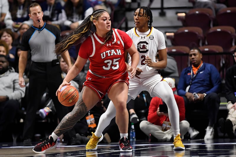 Utah forward Alissa Pili (35) is guarded by South Carolina forward Ashlyn Watkins (2) in the first half of an NCAA college basketball game, Sunday, Dec. 10, 2023, in Uncasville, Conn.