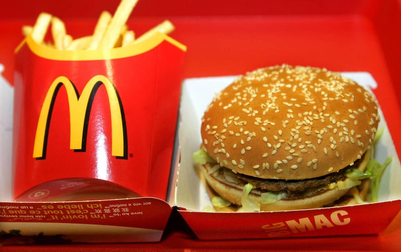 A Big Mac burger and French fries sit on a tray in a restaurant.