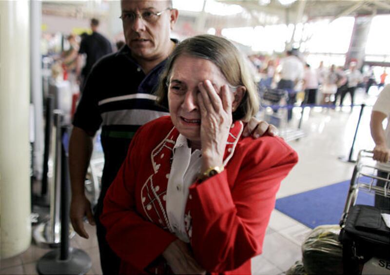 Dissident Cuban neurosurgeon Hilda Molina gets emotional at the boarding gate at the airport in Havana Saturday.