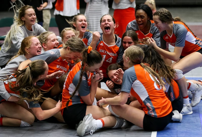 Skyridge celebrates their win over Springville in the 5A volleyball state championship match at the UCCU Center in Orem on Saturday, Nov. 3, 2018.