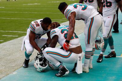 Miami Dolphins running backs Mark Walton and Kenyan Drake, console running back Kalen Ballage.