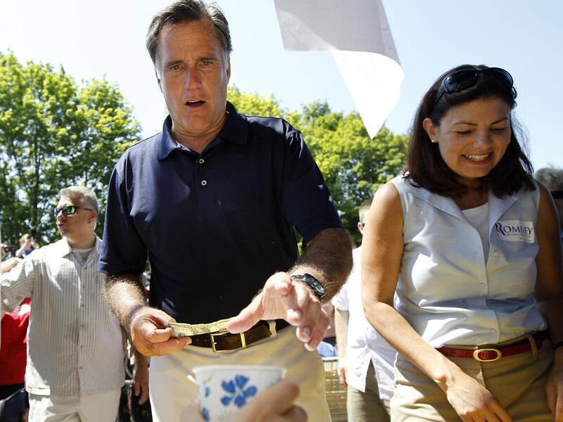 FILE - In this July 4, 2012 file photo, Republican presidential candidate Mitt Romney and Sen. Kelly Ayotte, R-N.H. make a lemonade stop as they walk in the Fourth of July Parade in Wolfeboro, N.H.
