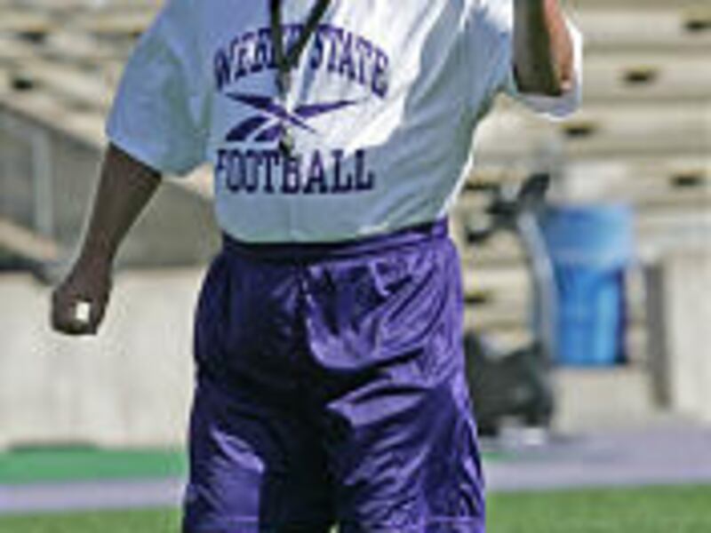 Weber State head coach Ron McBride shouts instructions at his players during a recent scrimmage at Stewart Stadium. McBride's return to the sidelines in the Beehive State is creating a buzz in Ogden.