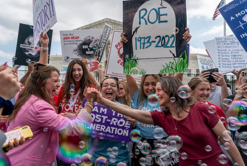 Anti-abortion protesters celebrate following the decision to overturn Roe v. Wade outside of the Supreme Court in Washington.