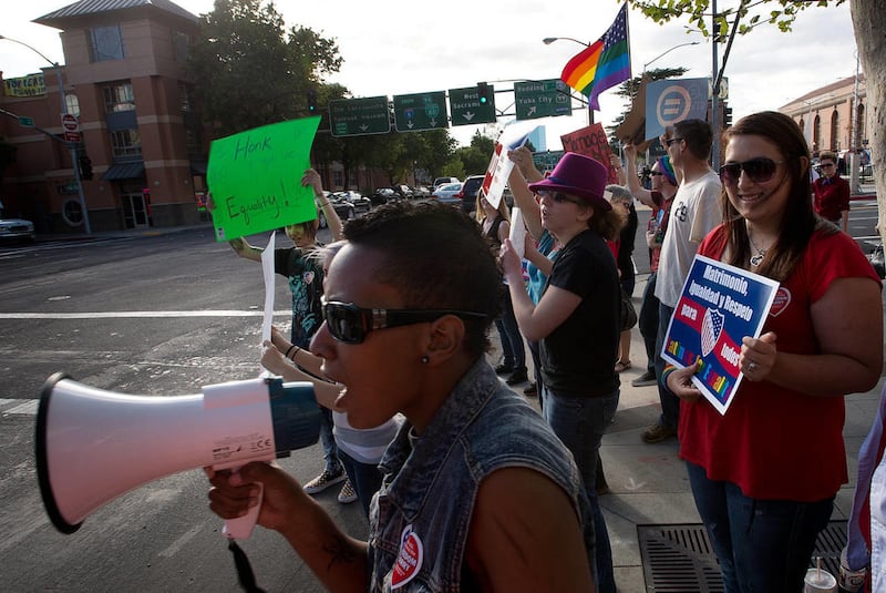 Rae Tate, of Sacramento, Calif., leads the supporters of gay marriage during a demonstration at the Federal Courthouse in Sacramento, Calif., on Tuesday, March 26, 2013.