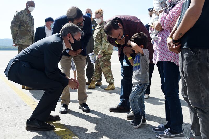 The U.S. secretary of state meets with a refugee family in Afghanistan.