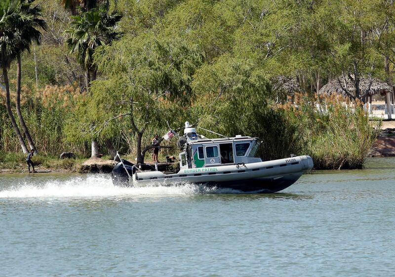U.S. Border Patrol agents patrol the Rio Grande by boat near the Mexican side of the river near Anzalduas Park in Mission, Texas.