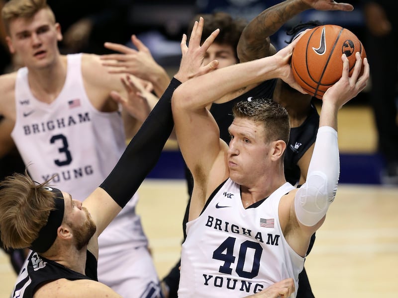 Brigham Young Cougars forward Kolby Lee (40) keeps the ball from Portland Pilots forward Mikey Henn (24) at the Marriott Center in Provo on Thursday, Jan. 21, 2021.