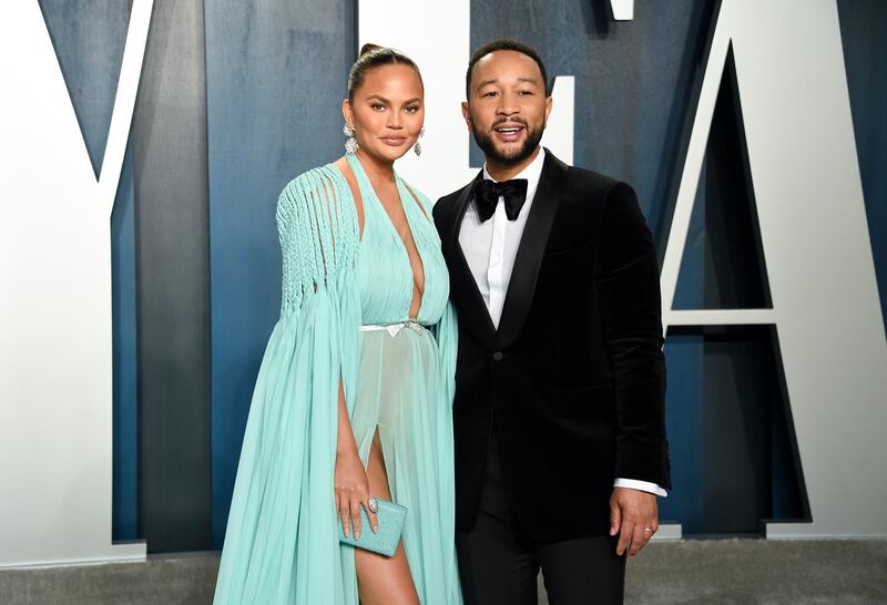 Chrissy Teigen, left, and husband John Legend arrive at the Vanity Fair Oscar Party on Sunday, Feb. 9, 2020, in Beverly Hills, Calif. (Photo by Evan Agostini/Invision/AP)
