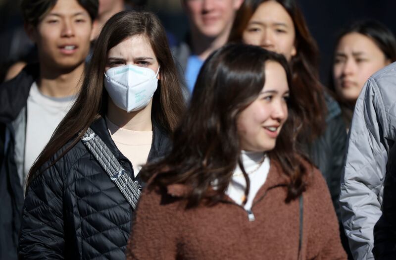 A young woman wears a KN95 mask in downtown Salt Lake City on Jan. 26, 2022.