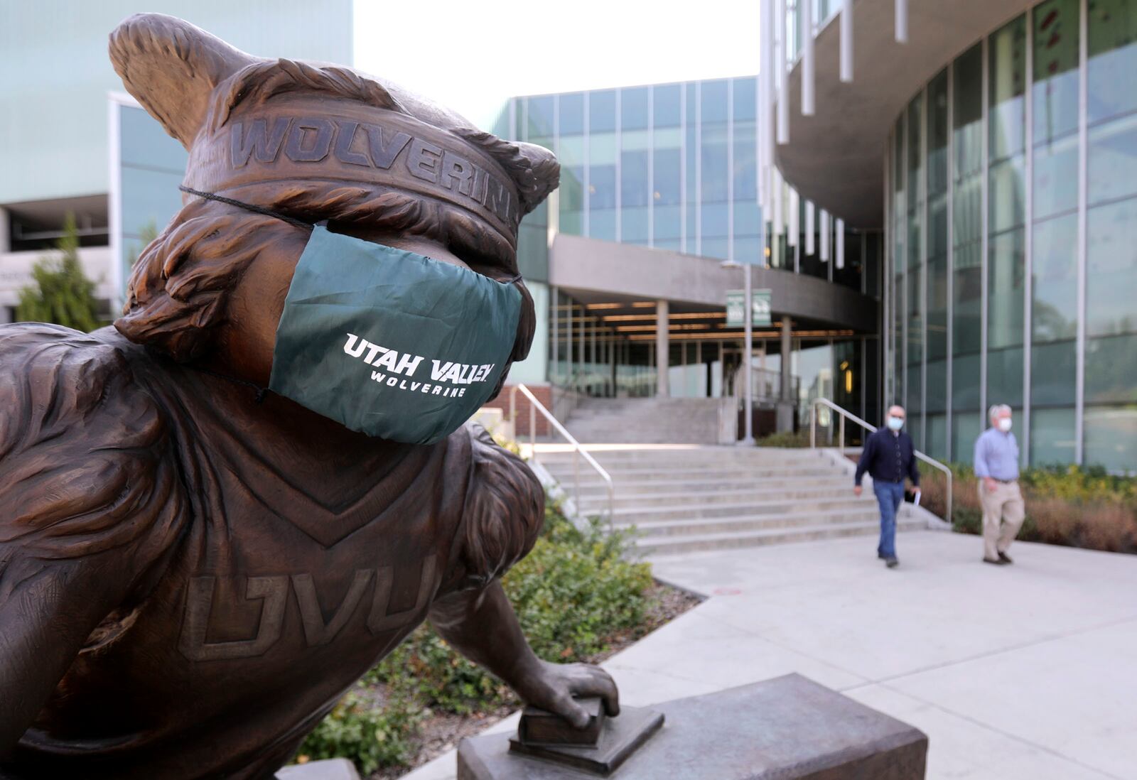 A statue of Utah Valley University’s Wolverine mascot wears a mask on the campus in Orem.