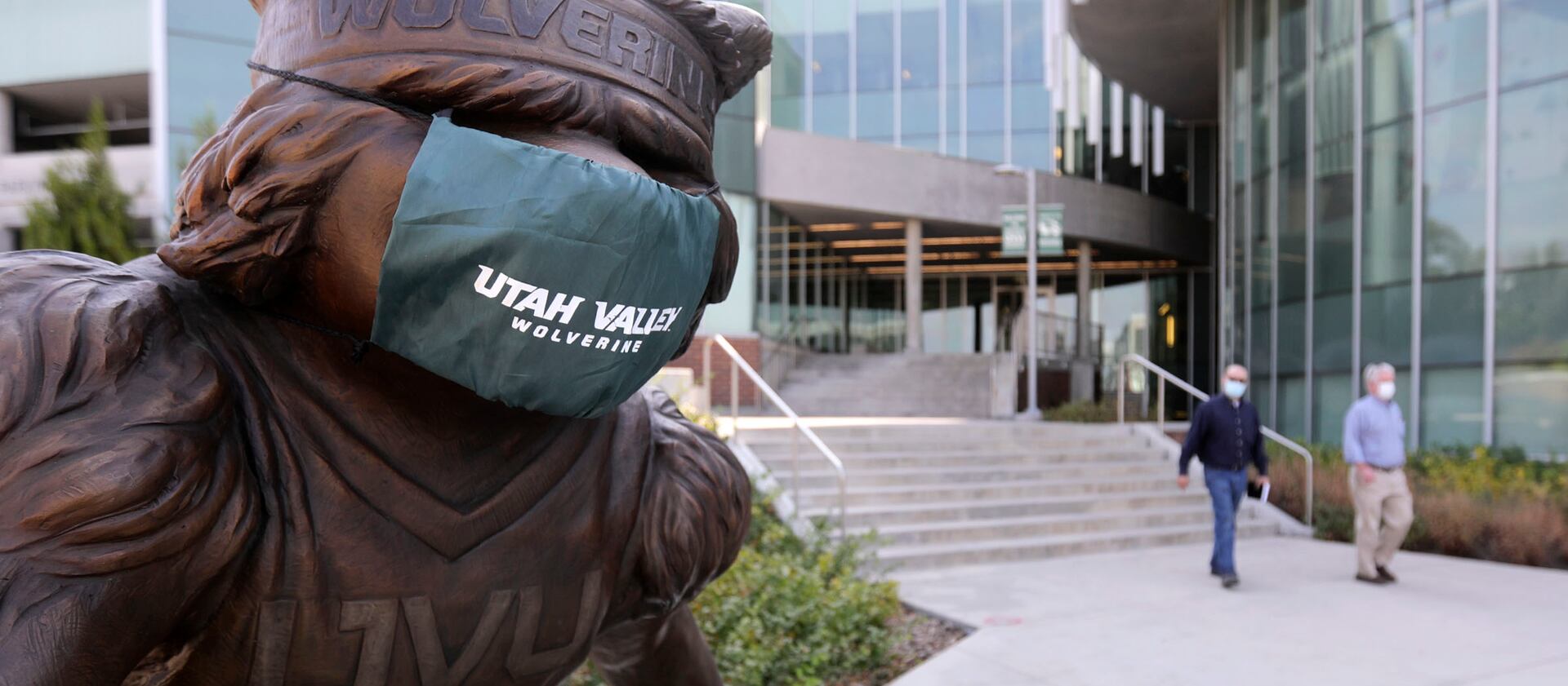 A statue of Utah Valley University’s Wolverine mascot wears a mask on the campus in Orem.
