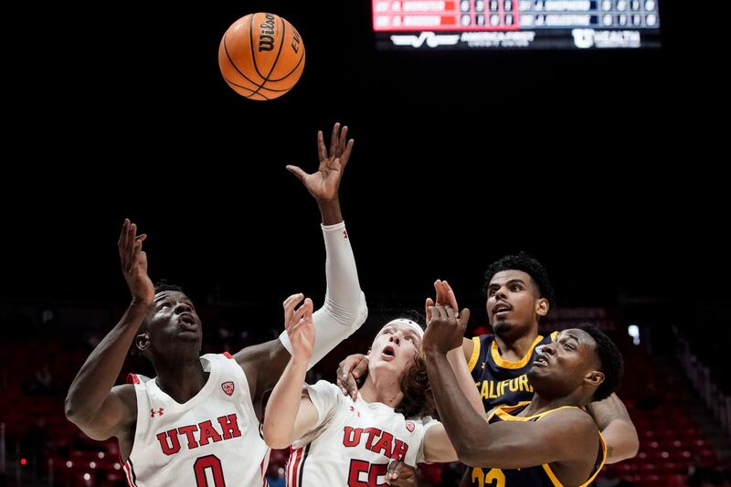 From left, Utah center Lahat Thioune, guard Gabe Madsen, California forward Andre Kelly and guard Jalen Celestine reach for a loose ball.