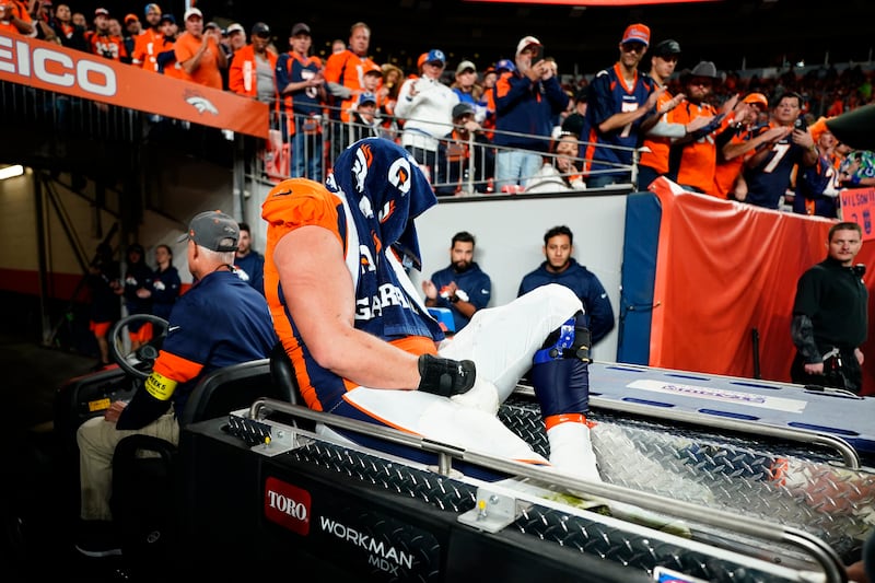 Denver Broncos offensive tackle Garett Bolles is carted off the field after an injury against the Indianapolis Colts during the second half of an NFL football game, Thursday, Oct. 6, 2022, in Denver.